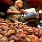 Seorang pedagang Yaman memperlihatkan kurma kering di sebuah pasar di kota tua Sanaa, Sabtu (11/5/2019). Buah kurma sangat identik saat bulan suci Ramadan, malah menjadi makanan wajib saat berbuka puasa. (Photo by Mohammed HUWAIS / AFP)