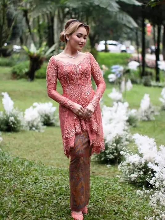 Kebaya peach model v-neck rancangan desainer Rikawirtjes ini tampak elegan dengan detail payet yang membuat penampilan Ayu terlihat glamor. (Instagram/ayutingting92).