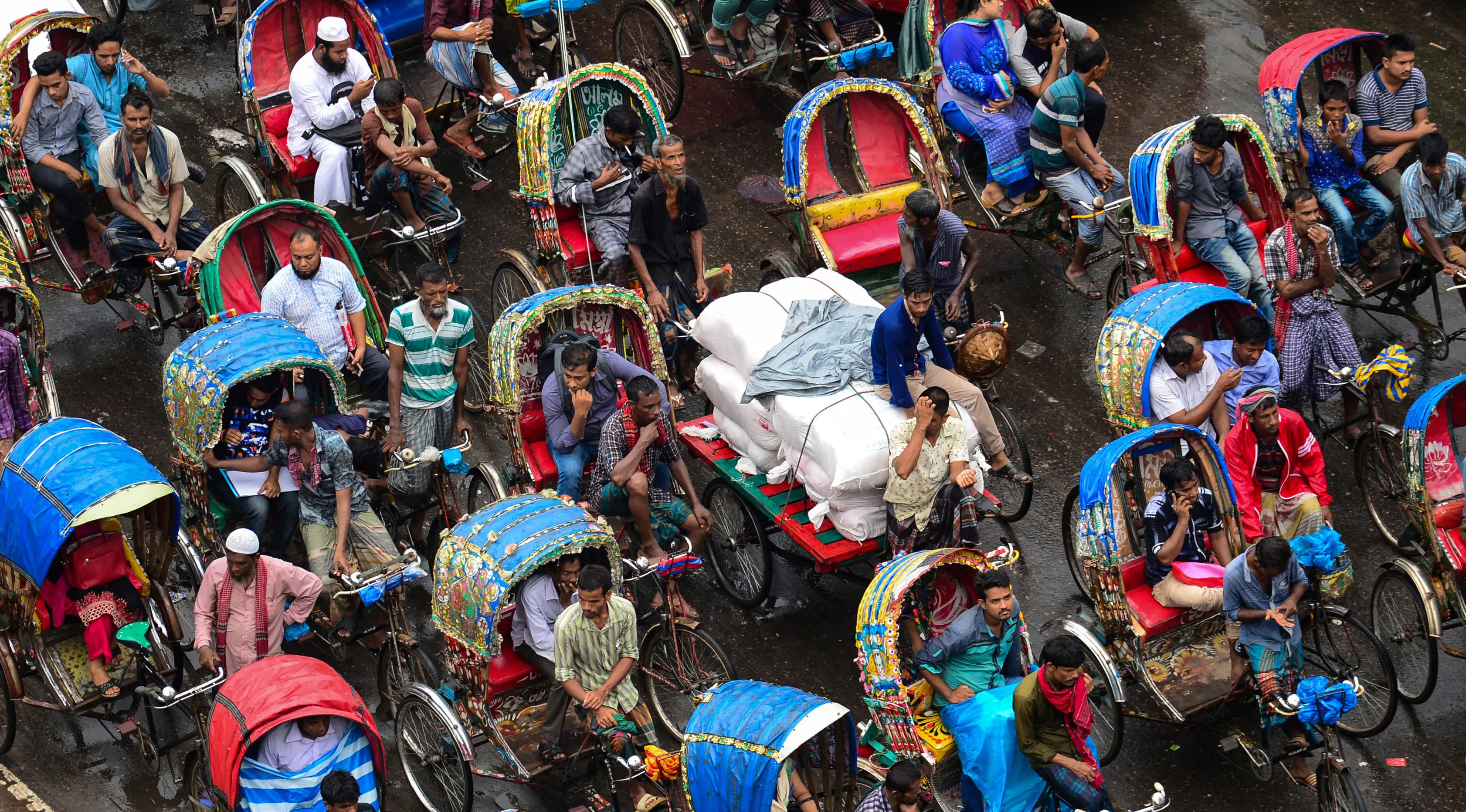 Sejumlah becak saat terjebak macet di sebuah persimpangan di Dhaka, Bangladesh, (23/7). Kemacetan di wilayah berpenduduk 8,9 juta jiwa ini disebabkan perkembangan kota tanpa terencana. (AFP Photo/ Munir Uz Zaman)