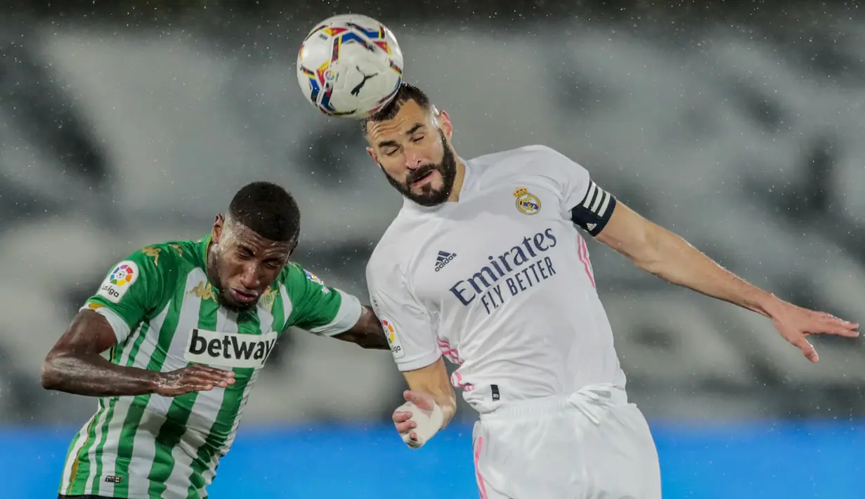Striker Real Madrid, Karim Benzema (kanan) berduel udara dengan bek Real Betis, Emerson dalam laga lanjutan Liga Spanyol 2020/2021 pekan ke-33 di Alfredo Di Stefano Stadium, Madrid, Sabtu (24/4/2021). Real Madrid bermain imbang 0-0 dengan Real Betis. (AP/Bernat Armangue)