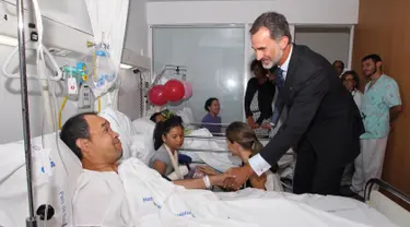 Raja Spanyol Felipe VI menjenguk korban serangan teror Barcelona yang sedang dirawat di Rumah Sakit Mar de Barcelona, Sabtu (19/8). Raja Felipe VI mencoba memberi semangat dan dukungan moral pascainsiden brutal yang mereka alami. (CASA REAL/AFP)