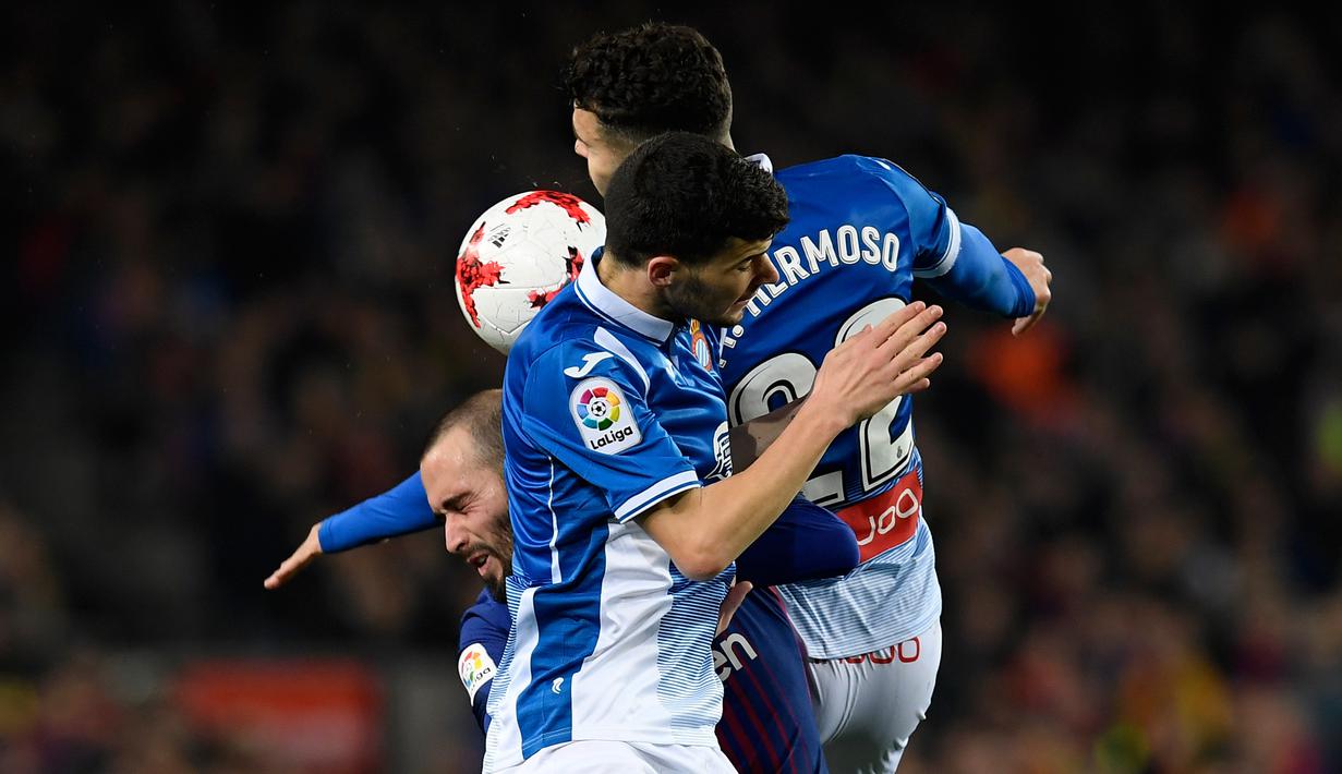 Gelandang Barcelona, Aleix Vidal berebut bola dengan bek Espanyol Mario Hermoso dan Aron Martin pada laga leg kedua perempat final Copa del Rey di Camp Nou, Kamis (25/1). Barcelona memetik kemenangan dua gol tanpa balas atas lawannya. (AP/Manu Fernandez)