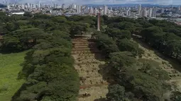 Pekerja menggunakan buldoser kecil untuk menggali lebih banyak kuburan di tengah pandemi COVID-19 di pemakaman Vila Formosa di Sao Paulo, Brasil, Rabu (7/4/2021). Kota Sao Paulo pada Rabu mulai menggali 600 kuburan tambahan setiap hari di pemakaman kotanya. (AP Photo/Andre Penner)