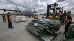 Personel TNI Angkatan Udara dan petugas Badan Nasional Penanggulangan Bencana (BNPB) bersiap memasukkan bantuan kemanusiaan dari pemerintah Indonesia untuk korban gempa bumi di Myanmar ke dalam pesawat angkut Hercules C-130 di Pangkalan Udara Halim Perdanakusuma, Jakarta, 31 Maret 2025. (BAY ISMOYO/AFP)