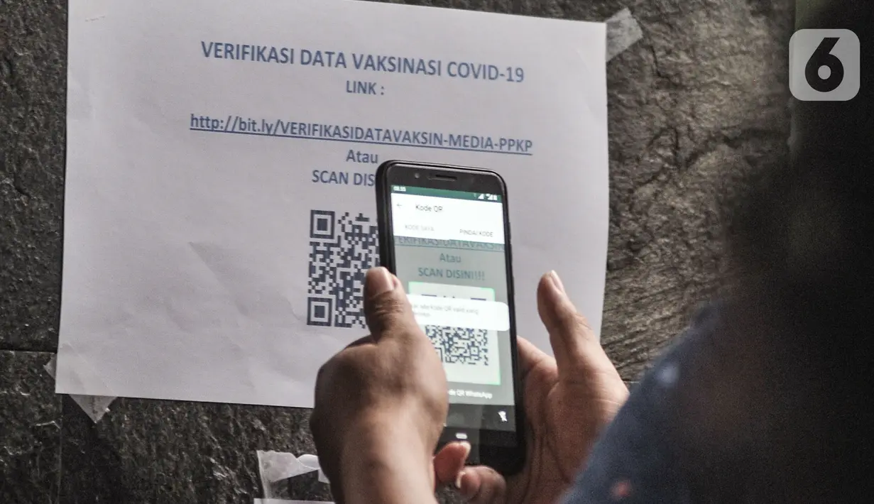 Jurnalis memindai barcode untuk memverifikasi kehadiran saat mengikuti vaksinasi Covid-19 di Balai Kota, Jakarta, Senin (29/3/2021). Vaksinasi untuk jurnalis ini bertujuan membantu kinerja para awak media dalam beraktivitas di masa pandemi Covid-19. (merdeka.com/Iqbal S. Nugroho)
