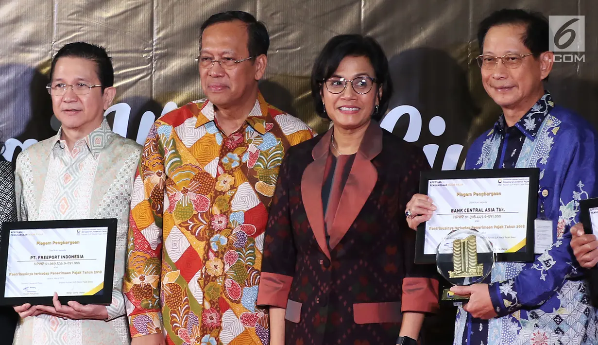 Menteri Keuangan Sri Mulyani (dua kanan) foto bersama dengan sejumlah penerima penghargaan Wajib Pajak 2019 di Jakarta, Rabu (13/3). Pada 2018, realisasi penerimaan pajak Kanwil DJP Wajib Pajak Besar mencapai Rp 418,73 triliun. (Liputan6.com/JohanTallo)