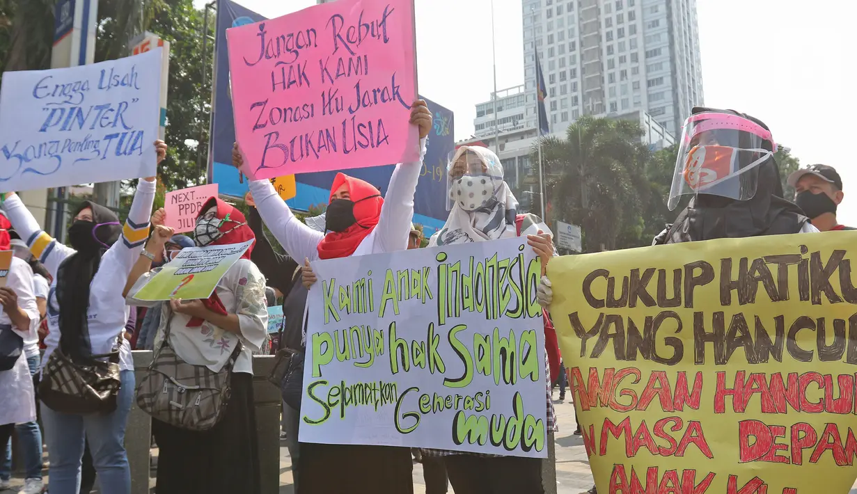 Sejumlah orang tua murid membawa poster berisi tuntutan saat demonstrasi di depan Kementerian Pendidikan dan Kebudayaan, Jakarta, Senin (29/6/2020). Mereka memprotes sistem Penerimaan Peserta Didik Baru (PPDB) DKI Jakarta yang seleksi penerimaannya berdasarkan usia. (Liputan6.com/Herman Zakharia)