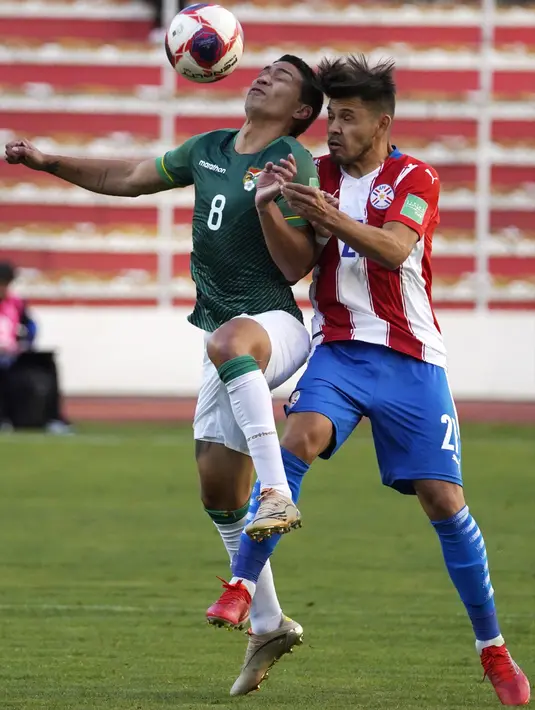 Pemain Bolivia Diego Bejarano (kiri) berebut bola dengan pemain Paraguay Oscar Romero pada pertandingan kualifikasi Piala Dunia 2022 di Stadion Hernando Siles, La Paz, Bolivia, Kamis (14/10/2021). Bolivia menang 4-0. (Javier Mamani/Pool via AP)