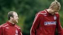 Wayne Rooney and Peter Crouch share a joke as they walk to the training ground for training at London Colney, North London, on October 7, 2008. AFP PHOTO/Glyn Kirk