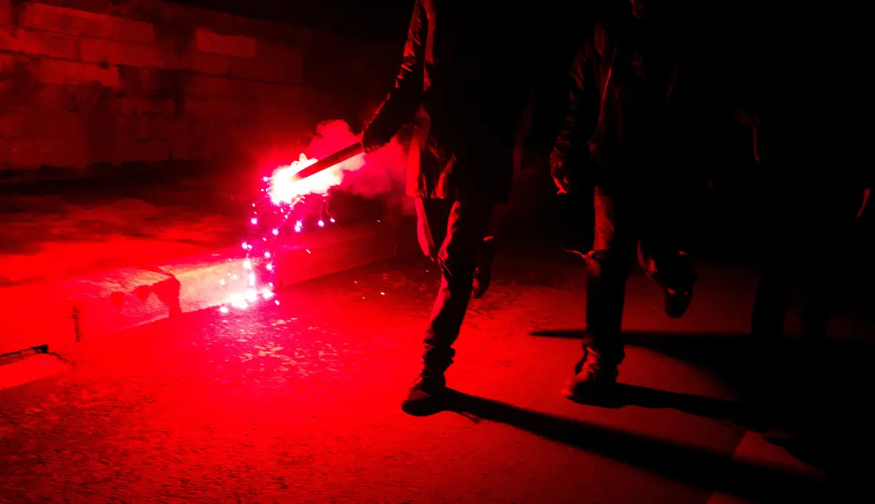 Pengunjuk rasa membakar flare selama aksi protes berujung kerusuhan di Aulnay-sous-Bois, pinggiran utara Paris, Rabu (8/2). Ketegangan dipicu kasus dugaan sodomi terhadap pemuda kulit hitam oleh anggota kepolisian. (AFP)