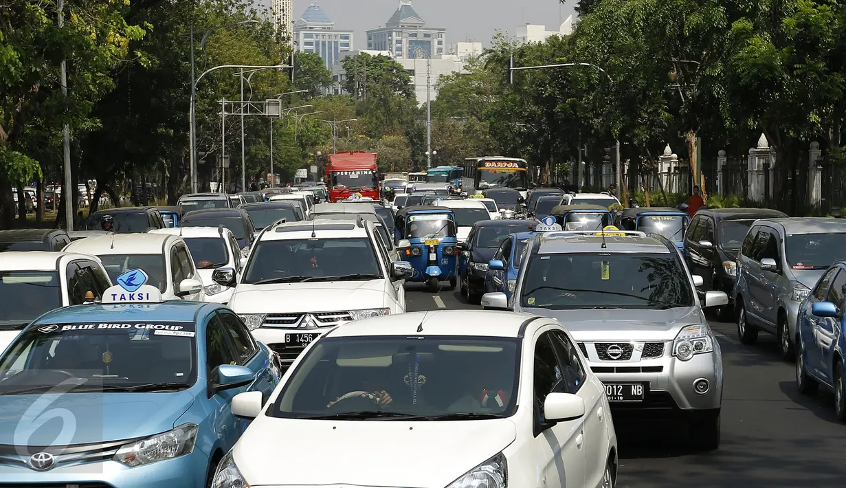 Puluhan kendaraan terkebak kemacetan akibat penutupan jalan Medan Merdeka menuju Istana Negara,  Jakarta, Jumat (30/10). Penutupan dilakukan terkait demo ribuan buruh yang menolak PP Pengupahan di depan Istana. (Liputan6.com/Yoppy Renato)