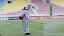Petugas menyemprot bendera sepak pojok dengan disinfektan sebelum pertandingan antara Persikabo 1973 melawan Arema FC pada laga Piala Menpora di Stadion Manahan, Solo, Minggu (21/3/2021). (Bola.com/M Iqbal Ichsan)