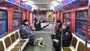 Petugas kepolisian Rusia duduk di dalam kereta Metro bertema Piala Dunia 2018 pada upacara pembukaan di Moskow, Selasa (28/11). Bagian dalam kereta Metro ini didedikasikan untuk sejarah Piala Dunia dari masa ke masa. (Mladen ANTONOV/AFP)