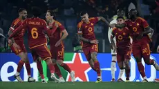 Bek AS Roma #23 Gianluca Mancini berselebrasi dengan rekan setimnya setelah mencetak gol ke gawang  AC Milan pada duel leg kedua perempat final Liga Europa 2023/2024 di Stadio Olimipico, Jumat (19/4/2024) dini hari WIB. (Filippo MONTEFORTE / AFP)