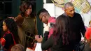 Presiden AS, Barack Obama dan ibu negara Michelle Obama membagikan coklat dan permen ke anak-anak dari Portico Selatan dan keluarga militer saat merayakan Halloween di Gedung Putih, Washington, Senin (31/10). (REUTERS / Jonathan Ernst)
