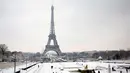 Suasana Menara Eiffel yang diselimuti salju di Paris, Prancis (7/2). Hujan salju yang sangat lebat membuat transportasi umum di paruh utara Prancis dan di Paris tidak dapat beroperasi. (AP Photo / Thibault Camus)