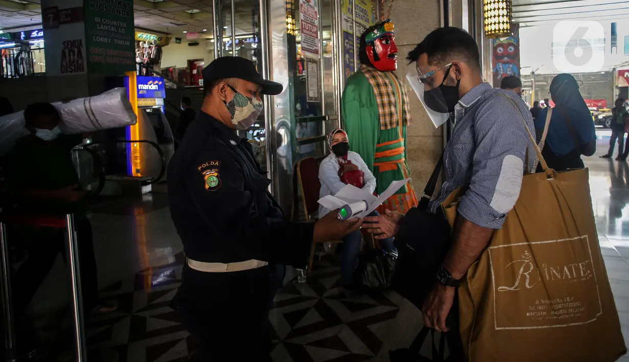 Warga menunjukan kartu vaksin di Pasar Tanah Abang, Jakarta, Selasa (27/7/2021). Dengan kembalinya dibuka Pasar Tanah Abang penjual mengeluhkan pembeli yang sangat sepi akibat peraturan baru yang mewajibkan menunjukkan kartu vaksin Covid-19 saat hendak berbelanja. (Liputan6.com/Johan Tallo)