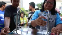 Warga mengambil air minum gratis saat run for water di CFD, Jakarta, Minggu (25/3). Run For Water kolaborasi PAM Jaya, Palyja, dan Aetra mengkampanyekan Hari Air Dunia 2018 mengajak masyarakat ayo peduli air Jakarta. (Liputan6.com/Angga Yuniar)