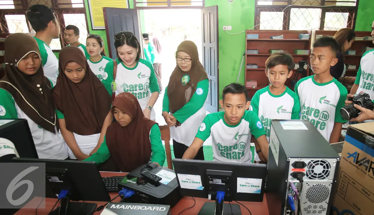 Senior GM CSR & Corcom PT Hero Supermarket Tbk Natalia Lusnita (tiga kiri) saat melihat siswa menggunakan perangkat computer di SDN Pamarican 2, Serang Baten, Sabtu (28/5). (Liputan6.com/Angga Yuniar)