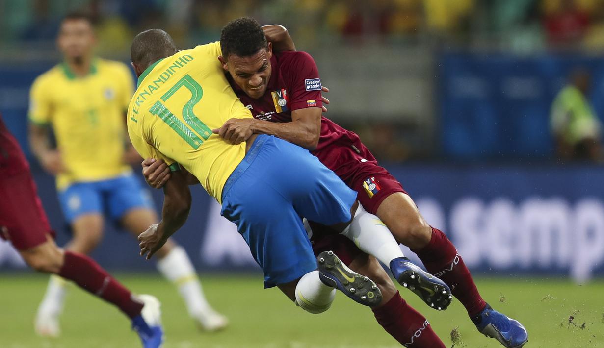 Duel Arquimides Figuera (kanan) asal Venezuela dengan Fernandinho geandang bertahan asal Brasil di laga penyisihan Grup A Copa America 2019 di Arena Fonte Nova, Salvador, Brasil. (AP/Natacha Pisarenko)