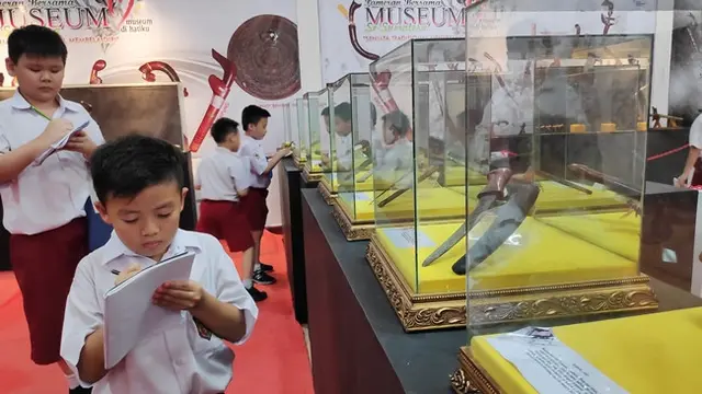 Murid SD yang berkunjung ke Museum Sang Nila Utama Riau mencatat nama koleksi yang ada.