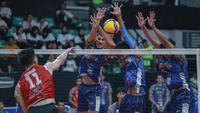 Opposite Hitter Jakarta LavAni Livin Transmedia, Dimas Saputra, mendapatkan adangan dari tiga  pemain Surabaya Samator saat melakukan spike dalam duel Final Four Proliga 2025 di GOR Sritex Arena, Solo, Kamis (1/5/2025). (Bola.com/Radifa Arsa)
