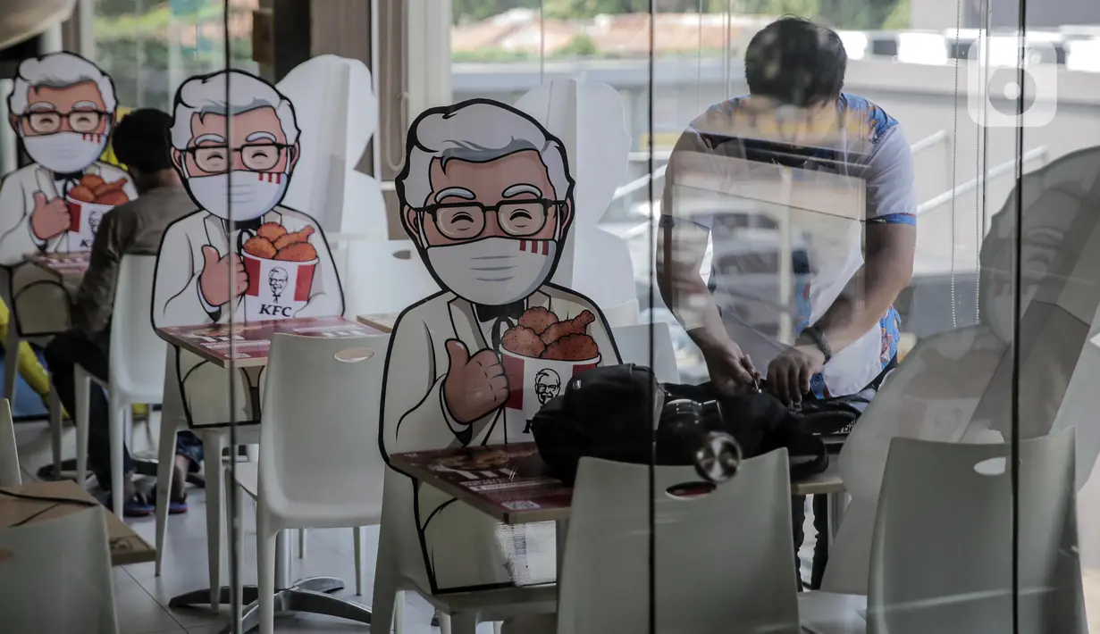 Banner bergambar karakter terlihat di KFC Salemba, Jakarta, Selasa (23/6/2020). Banner bergambar tersebut berguna untuk pembatas bagi pengunjung yang makan di tempat saat fase kenormalan baru. (Liputan6.com/Faizal Fanani)