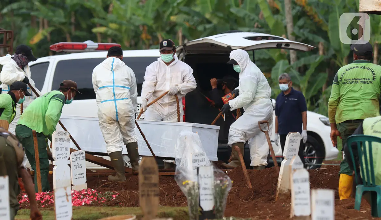 Petugas melakukan pemakaman jenazah dengan protokol COVID-19 di TPU Pondok Ranggon, Jakarta, Kamis (12/10/2020). Gubernur DKI Jakarta Anies Baswedan menganggarkan Rp254 miliar guna menambah lahan pemakaman jenazah dengan protokol Covid-19. (Liputan6.com/Helmi Fithriansyah)