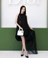 Jisoo mengenakan gaun pesta hitam berbahan silk pleated dari koleksi Dior Autumn-Winter 2026–2027. Ia melengkapi tampilannya dengan berbagai aksesori Dior yang semakin menegaskan kesan elegan dan klasik. [Image Credit: Getty Images/DIOR]