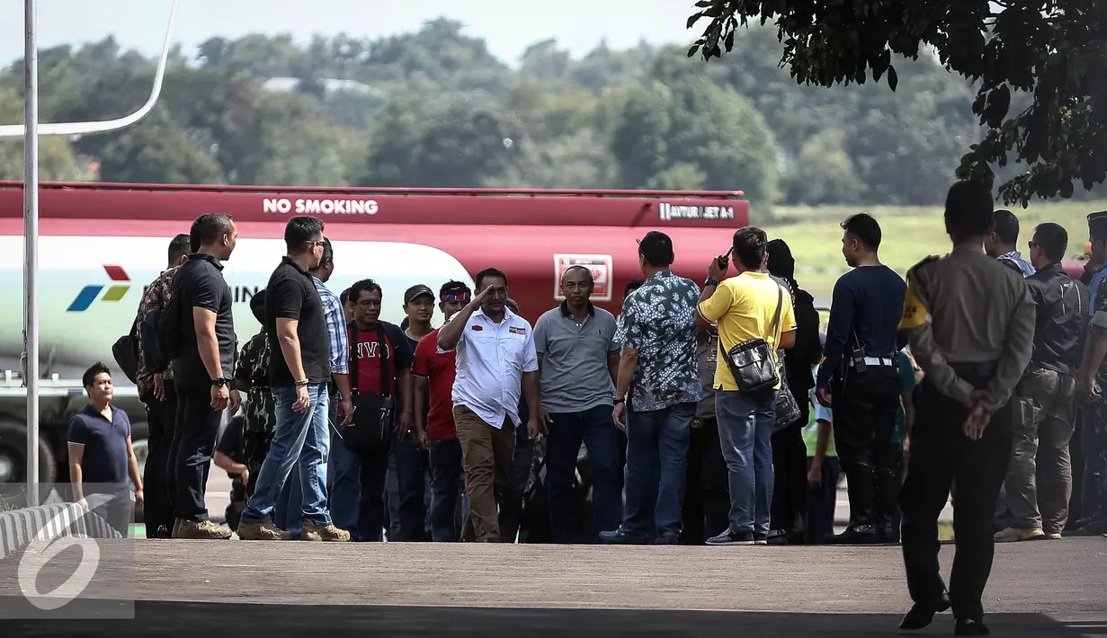Kapolda Metro Jaya Irjen Mochamad Iriawan menyambut kedatangan petugas kepolisian yang membawa tersangka Ridwan Sitorus saat tiba di Bandara Halim Perdana Kusuma, Jakarta, Minggu (1/1). (Liputan6.com/Faizal Fanani)