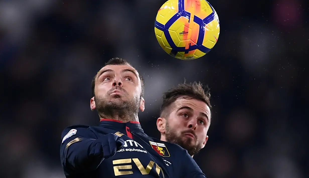 Pemain Genoa, Goran Pandev berebut bola dengan gelandang Juventus, Miralem Pjanic dalam lanjutan pertandingan Serie A di Stadion Allianz, Turin, Senin (22/1). Juventus mengatasi perlawanan Genoa dengan skor 1-0. (MARCO BERTORELLO / AFP)