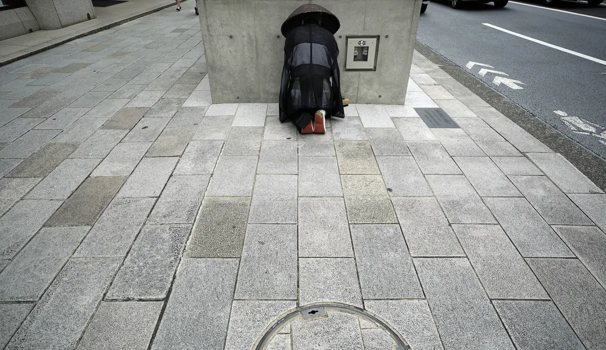 Seorang biksu Buddha bersiap untuk salat di distrik perbelanjaan Ginza di Tokyo, Selasa (1/9/2020). Ibukota Jepang mengonfirmasi lebih dari 170 kasus virus korona pada hari Selasa. (AP Photo/Eugene Hoshiko)