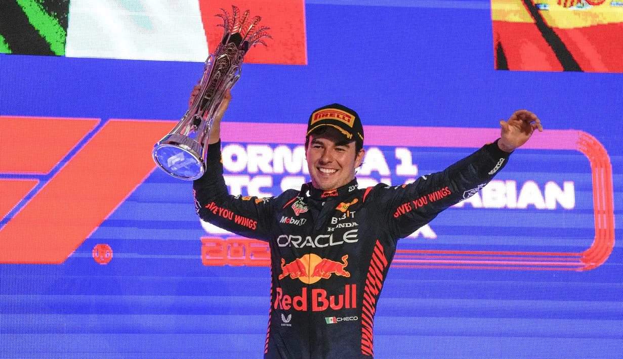 Pebalap Red Bull, Sergio Perez merayakan kemenangan setelah finis pertama saat Formula 1 GP Arab Saudi 2023 yang berlangsung di Jeddah Corniche Circuit, Senin (20/03/2023) WIB. Kemenangan tersebut menjadi yang kelima di ajang balap Formula 1 bagi pebalap asal Meksiko tersebut. (AP Photo/Hassan Ammar)