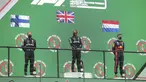 Pembalap Mercedes Lewis Hamilton (tengah) berdiri di podium bersama pembalap Mercedes Valtteri Bottas dan pembalap Red Bull Max Verstappen selama Formula 1 GP Portugaldi Algarve International Sirkuit di Portimao, Portugal, Minggu (25/10/2020).  (Jose Sena Goulao, Pool via AP)