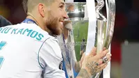 Kapten Real Madrid Sergio Ramos menyentuh trofi setelah memenangkan pertandingan final Liga Champions antara Real Madrid dan Liverpool di Stadion NSK Olimpiyskiy, Ukraina (26/5). (AP/Sergei Grits)