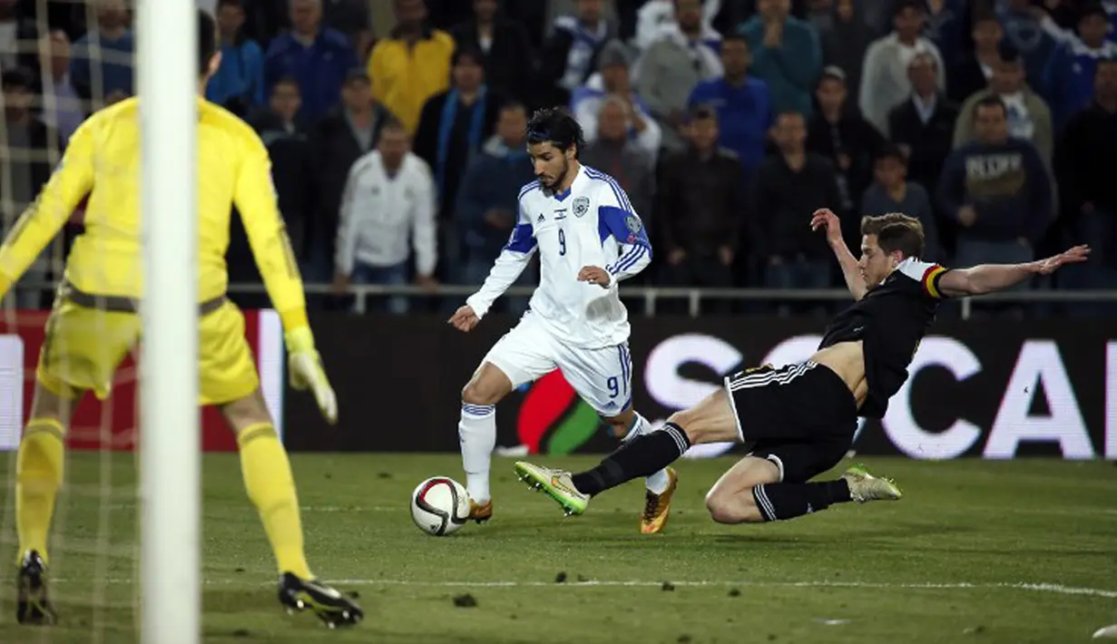 Gelandang Israel, Lior Refaelov (tengah) berusaha melewati bek Belgia Jan Vertonghen pada kualifikasi Piala Eropa 2016 di Teddi Malcha Stadium, Jerusalem,Rabu (1/4/2015). Belgia menang 1-0 melawan Israel. (AFP PHOTO/Thomas Coex)