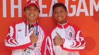 Dua atlet menembak Indonesia, Ahmad Rifqi Mukhlisin dan Aubrey Rasendriya, berhasil merengkuh medali emas serta perak pada nomor mixed metallic silhouette air rifle di SEA Games 2019, Minggu (8/12/2019). (dok. PB Perbakin)