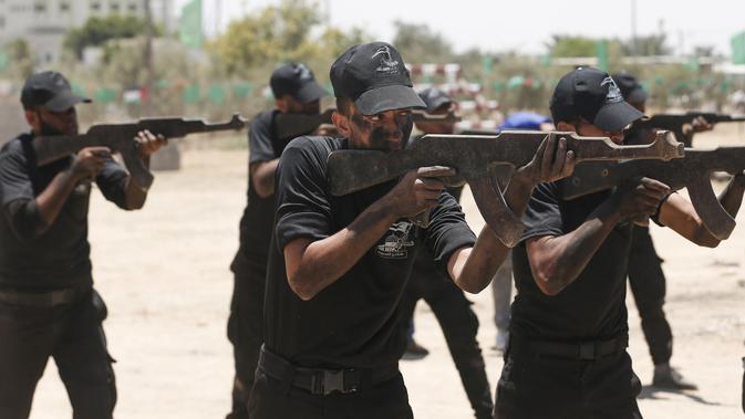 Sejumlah kadet Palestina berlatih menembak dengan militer Hamas, Brigade Ezzedin al-Qassam, di Kota Gaza (20/7/2019). Serangkaian tes militer pun harus dilakukan para kadet yang dimulai dari uji fisik, ketangkasan hingga menembak. (AFP Photo/Mahmud Hams)