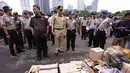Aparat kepolisian mengungkap hasil operasi pemberantasan premanisme di Mapolda Metro Jaya, Jakarta, Selasa (3/2/2015). Gubernur DKI Jakarta, Basuki T Purnama (tengah) saat melihat barang bukti yang diamankan. (Liputan6.com/JohanTallo)