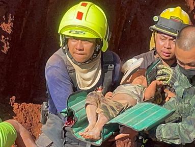 Setelah operasi darurat semalam, petugas penyelamat dan militer membawa seorang anak berusia 1 tahun dari lubang yang dalam di Provinsi Tak, Thailand, Selasa (7/2/2023). Balita asal Myanmar itu jatuh ke lubang sedalam 15 meter yang digunakan untuk pipa air tanah kemarin malam. (AP Photo/Chiravuth Rungjamratratsami)