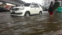 Mobil mewah menerjang banjir (Liputan6.com/ Ahmad Romadoni)