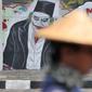 Mural bertulis 'Menolak RKUHP Bukan Menunda' terpampang pada dinding di Jalan Pemuda, Rawamangun, Jakarta, Selasa (1/10/2019). Mural tersebut respons dari seniman Jakarta terhadap RUU KUHP yang dinilai mencederai tatanan demokrasi. (merdeka.com/Iqbal Nugroho)