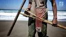 Marsiono memegang sebilah bambu hasil tangkapan undur-undur atau yutuk di bibir Pantai Bocor, Kabupaten Kebumen, Jawa Tengah, Sabtu (05/5). Hasil tangkapannya dijual ke pedagang atau tempat pelelangan ikan. (Liputan6.com/Fery Pradolo)