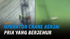 Seolah sedang tak bertugas, ia menjahili pengunjung pantai dengan crane.