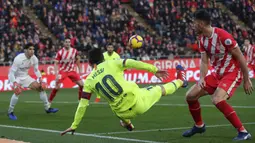 Striker Barcelona, Lionel Messi, menendang bola saat melawan Girona pada laga La Liga di Stadion Montilivi, Minggu (27/1). Barcelona menang 2-0 atas Girona. (AP/Manu Fernandez)