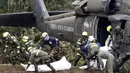 Petugas saat melakukan evakuasi korban dari puing-puing pesawat LaMia Airlines yang terjatuh di areal hutan Kolombia, (29/11/2016).  (Reuters/Jaime Saldarriaga)
