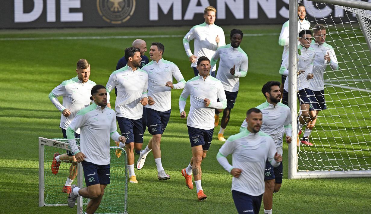 Para pemain Swiss melakukan pemanasan saat mengikuti sesi latihan tim di Stadion RheinEnergie, Cologne, Jerman (12/10/2020). Swiss akan bertanding melawan Jerman dalam lanjutan UEFA Nations League Divisi A Grup 4 (A4). (AP Photo/Martin Meissner)