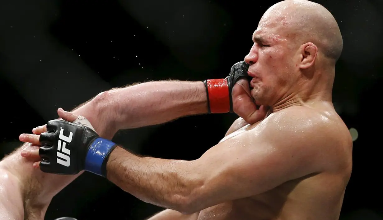 Petarung Ben Rothwell memukul muka Junior Dos Santos (kanan) dalam pertarungan kelas berat Ultimate Fighting Championship (UFC) di Arena Zagreb, Zagreb, Kroasia, (10/4/2016). (Reuters/Antonio Bronic)