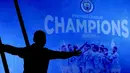 Seorang fans Manchester City merayakan keberhasilan timnya memastikan merebut gelar juara Liga Inggris 2020/2021 di luar Etihad Stadium, Selasa (11/5/20221) sesaat setelah kekalahan pesaing terdekat Manchester United 1-2 oleh Leicester City di Old Trafford. (AP/Jon Super)