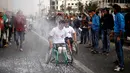 Para peserta saat bersaing mencapai garis finis dalam perlombaan kursi roda di Kota Gaza, (29/11). Lomba ini diselenggarakan untuk para warga yang mengalami cacat fisik akibat konflik sejak tahun 2008 dengan militer Israel. (REUTERS/Suhaib Salem)